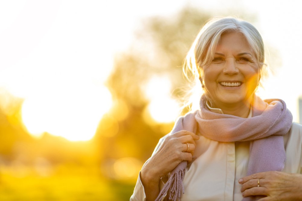 Senior,Woman,Enjoying,Autumn,Colors,At,Sunset